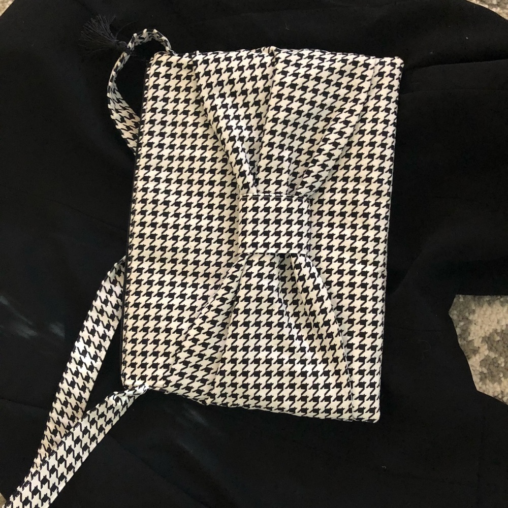 Black and white clutch with decorative bow.